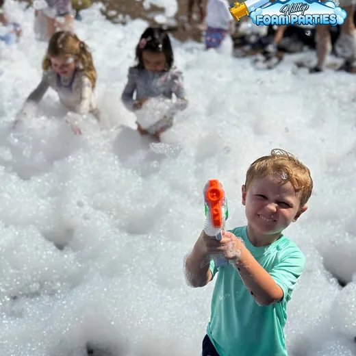 Child playing in foam at a summer event