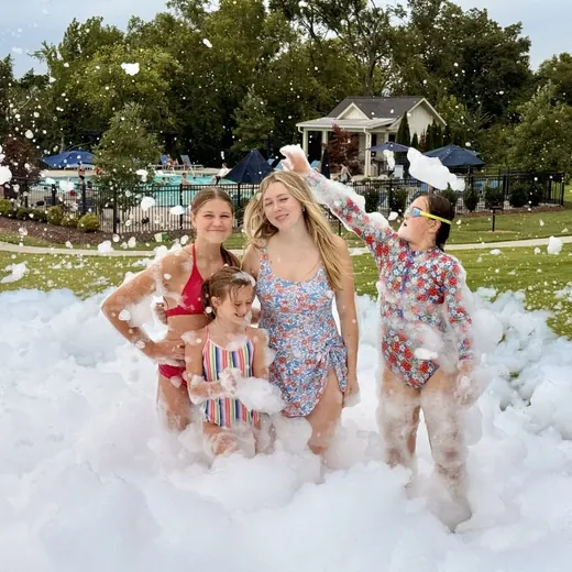 Family playing together at a neighborhood foam party