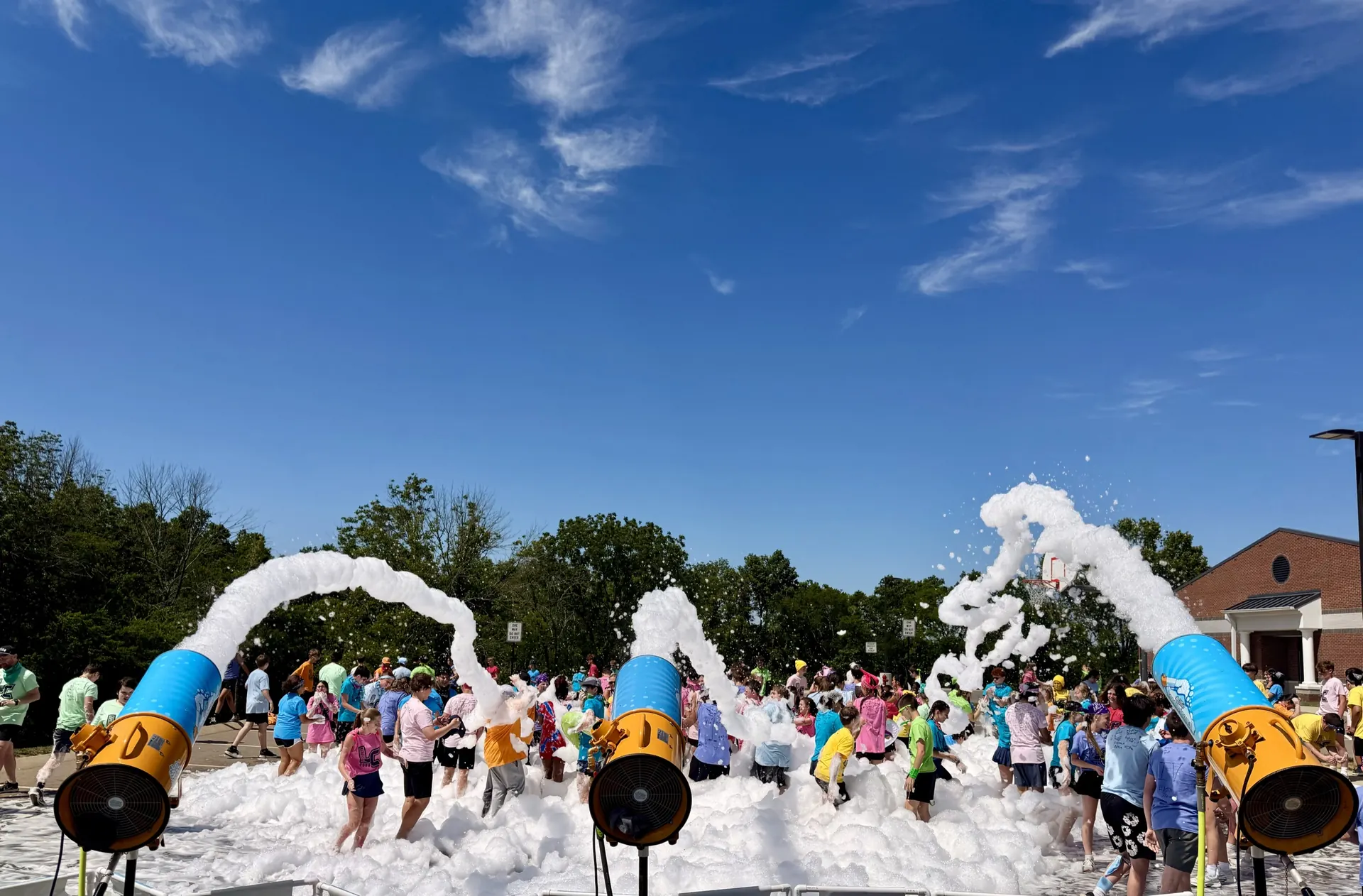 Five Hilltop foam cannons spraying foam at once at a large school event