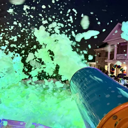Glow foam blasting from a cannon at night