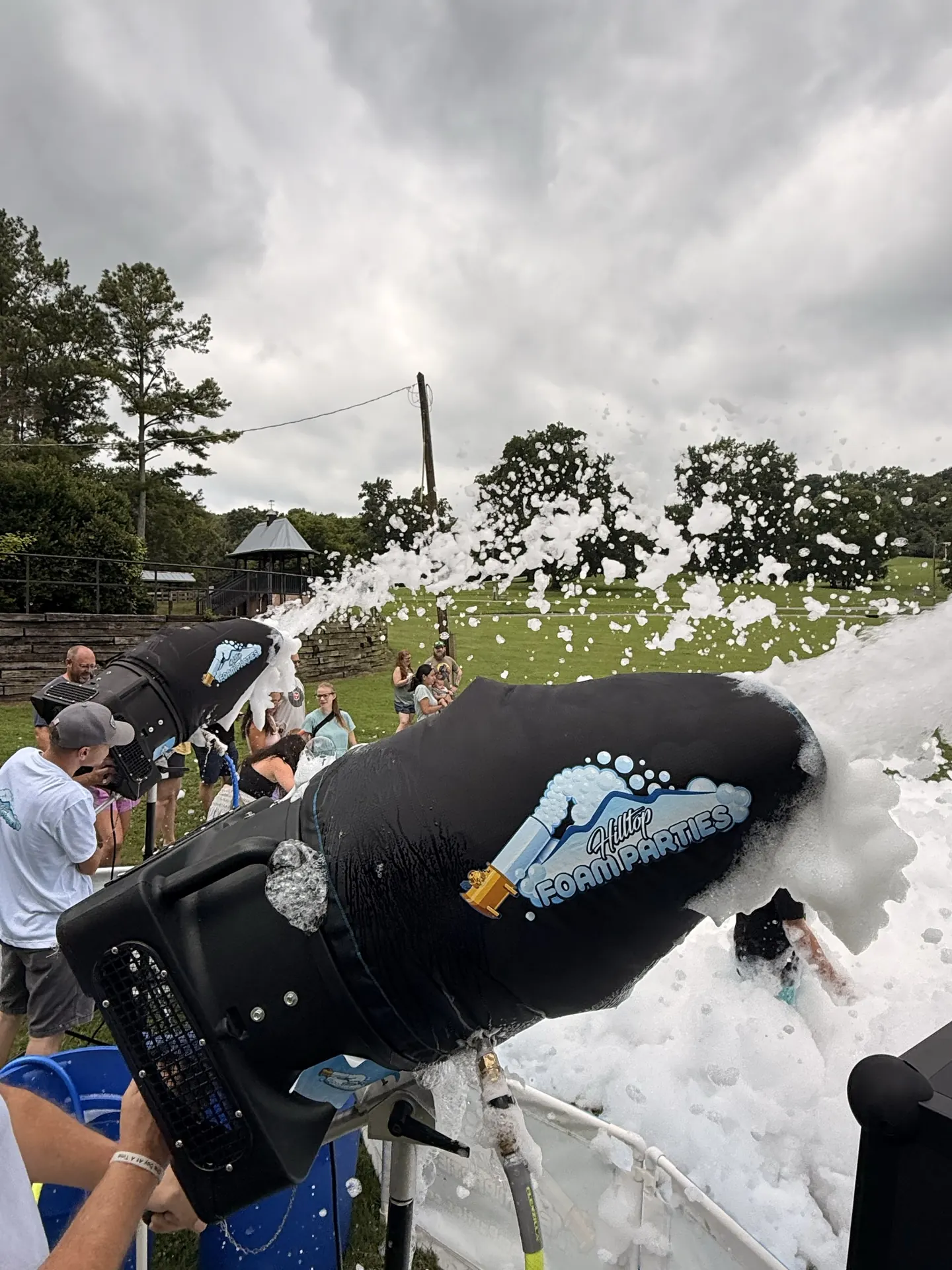 Close up of a Hilltop foam cannon spraying foam at an outdoor event