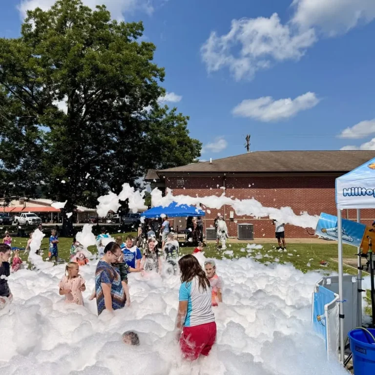 Neighborhood Fourth of July foam party with multiple foam cannons