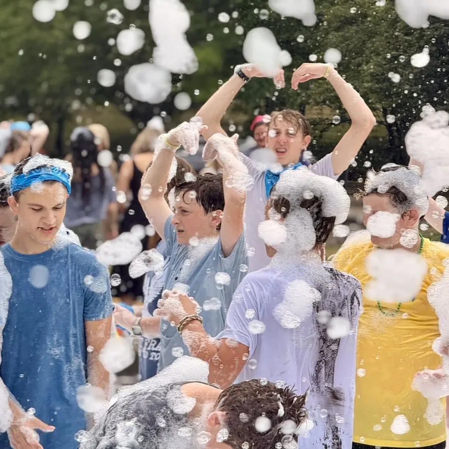 Students celebrating in foam at a school event