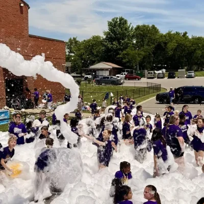Church kids playing in foam on a sunny day