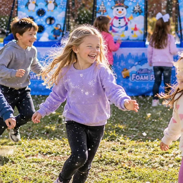 Kids laughing and running through falling snow at a Hilltop snow party